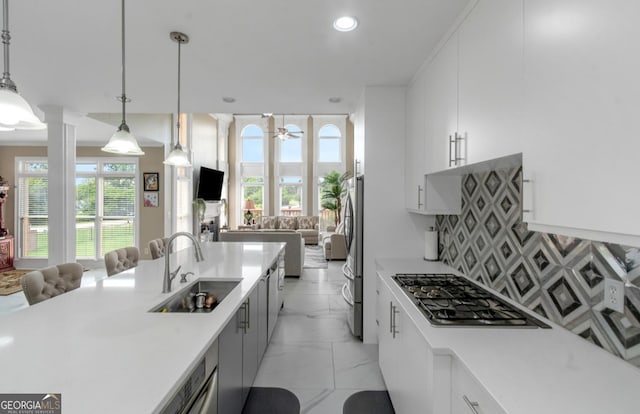 413 Canterbury Way, Jonesboro, GA 30236 - kitchen featuring a sink, open floor plan, stainless steel appliances, light countertops, and decorative light fixtures