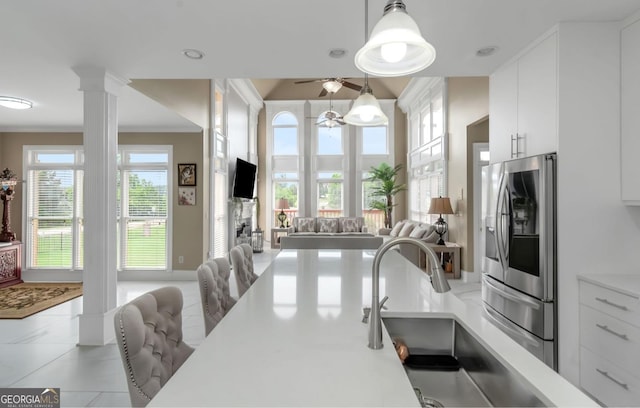 413 Canterbury Way, Jonesboro, GA 30236 - kitchen featuring stainless steel refrigerator with ice dispenser, open floor plan, a ceiling fan, white cabinetry, and light countertops