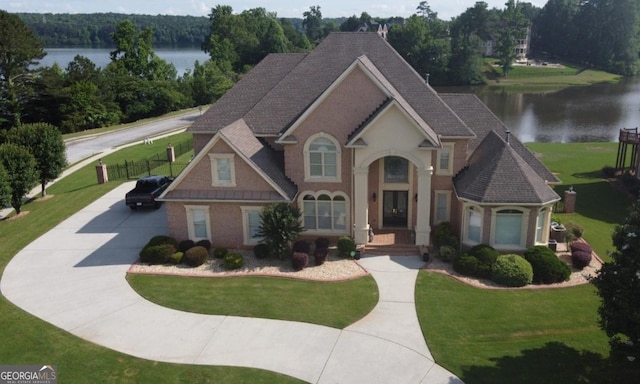 413 Canterbury Way, Jonesboro, GA 30236 - view of front facade with a water view, a front lawn, driveway, and roof with shingles