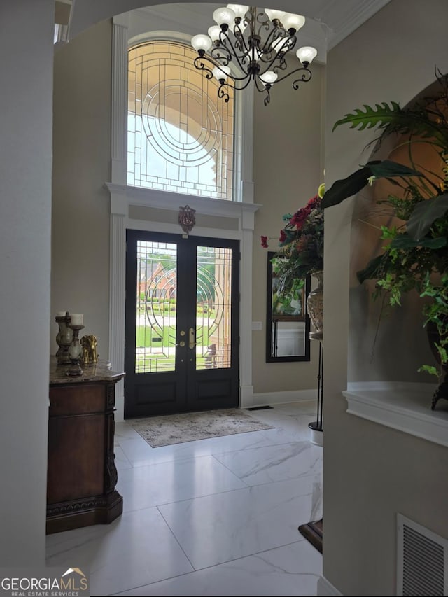 413 Canterbury Way, Jonesboro, GA 30236 - foyer entrance featuring a chandelier, a towering ceiling, marble finish floors, and french doors