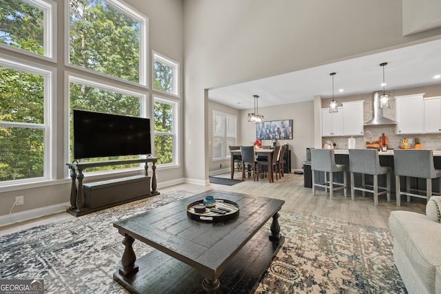 2118 Harmony Dr, Canton, GA 30115 - living room featuring light wood finished floors, recessed lighting, and a high ceiling