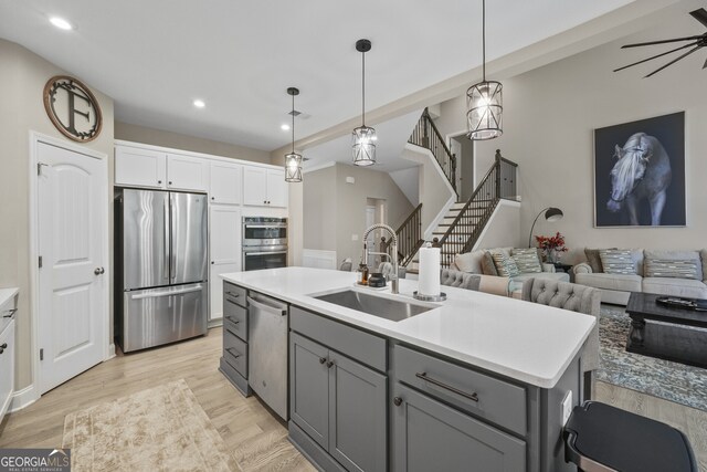 2118 Harmony Dr, Canton, GA 30115 - kitchen featuring appliances with stainless steel finishes, gray cabinetry, open floor plan, light countertops, and recessed lighting
