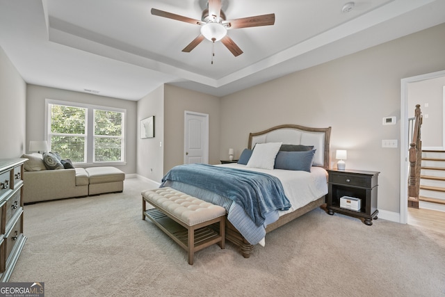 2118 Harmony Dr, Canton, GA 30115 - bedroom featuring light carpet, a tray ceiling, and a ceiling fan