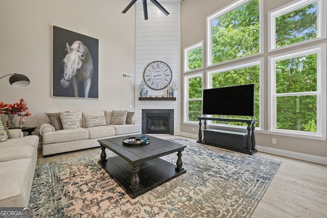 2118 Harmony Dr, Canton, GA 30115 - living area with ceiling fan, wood finished floors, and a fireplace