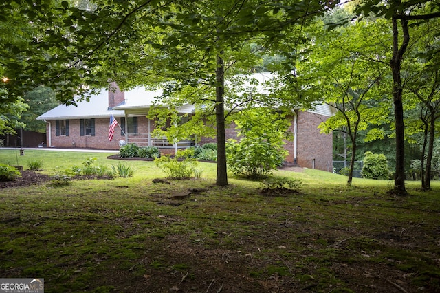 323 Mccartan Trl, Clarkesville, GA 30523 - view of green lawn with a porch