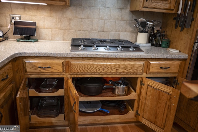 323 Mccartan Trl, Clarkesville, GA 30523 - kitchen featuring gas cooktop, brown cabinetry, backsplash, and wood finished floors