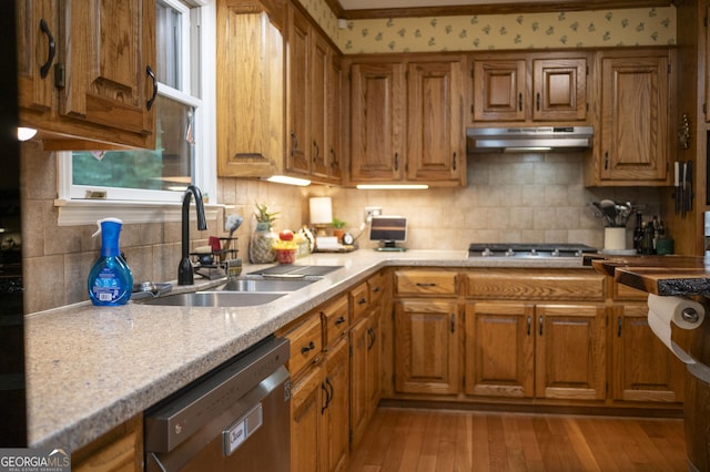 323 Mccartan Trl, Clarkesville, GA 30523 - kitchen with under cabinet range hood, dishwashing machine, brown cabinets, and a sink