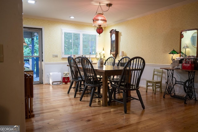323 Mccartan Trl, Clarkesville, GA 30523 - dining space featuring crown molding, wood finished floors, wallpapered walls, and a chandelier