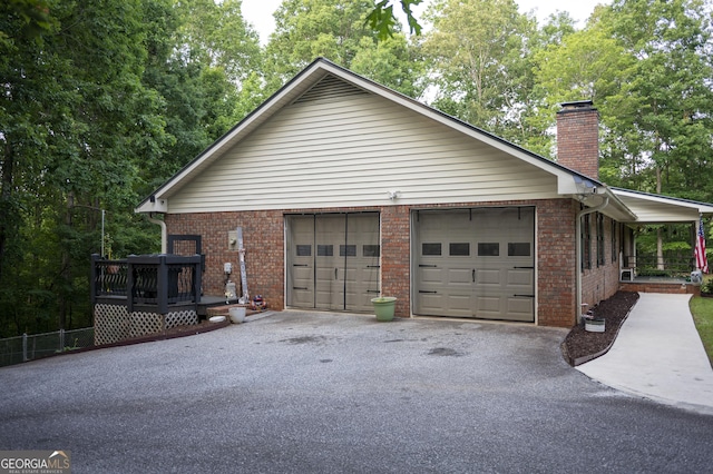323 Mccartan Trl, Clarkesville, GA 30523 - view of home's exterior with a chimney, brick siding, a garage, and asphalt driveway