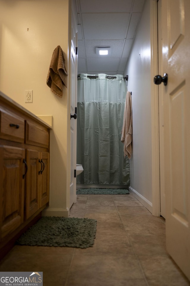 323 Mccartan Trl, Clarkesville, GA 30523 - bathroom with a paneled ceiling, baseboards, and curtained shower