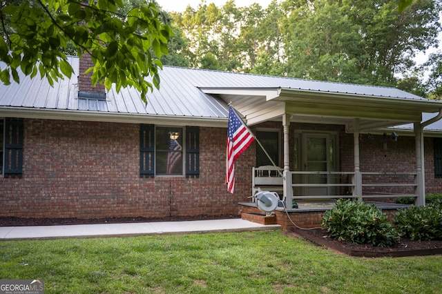 323 Mccartan Trl, Clarkesville, GA 30523 - ranch-style house featuring a front lawn, metal roof, brick siding, and a porch