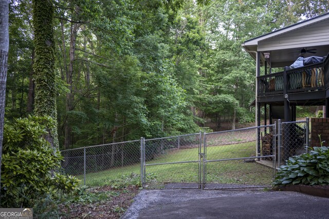 323 Mccartan Trl, Clarkesville, GA 30523 - view of yard featuring a gate, a ceiling fan, and a view of trees