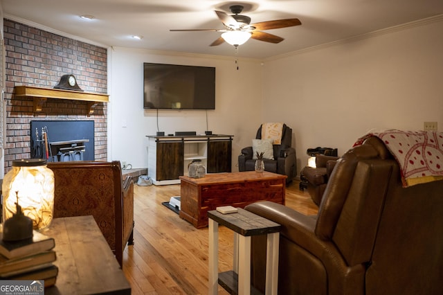 323 Mccartan Trl, Clarkesville, GA 30523 - living area with ornamental molding, a ceiling fan, wood finished floors, and a brick fireplace