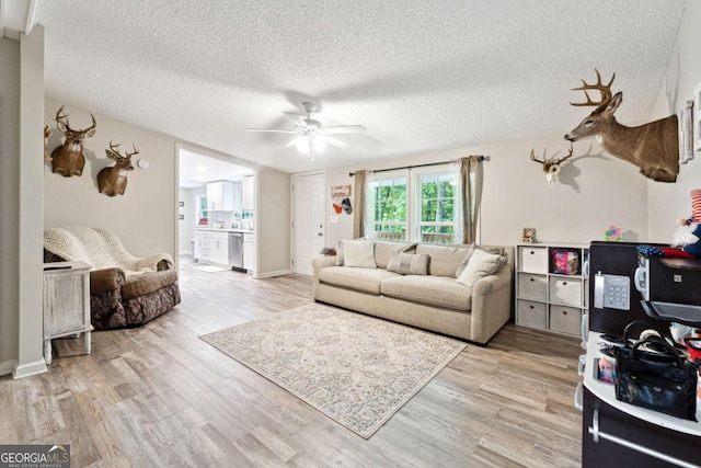 187 Angers Ct, Dahlonega, GA 30533 - living room with light wood-style floors, a ceiling fan, and a textured ceiling
