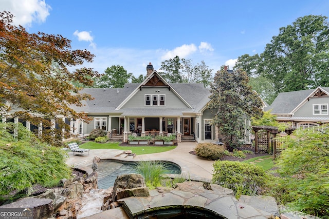 114 Trinity Hollow Dr, Canton, GA 30115 - rear view of property with a chimney, an outdoor pool, a patio area, and a deck
