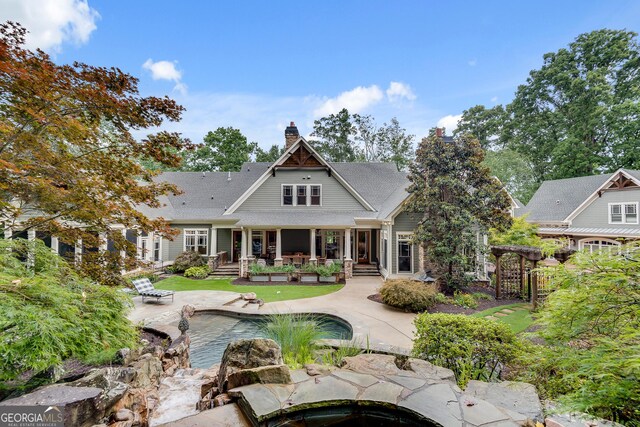 114 Trinity Hollow Dr, Canton, GA 30115 - back of house featuring a chimney, an outdoor pool, and a patio area