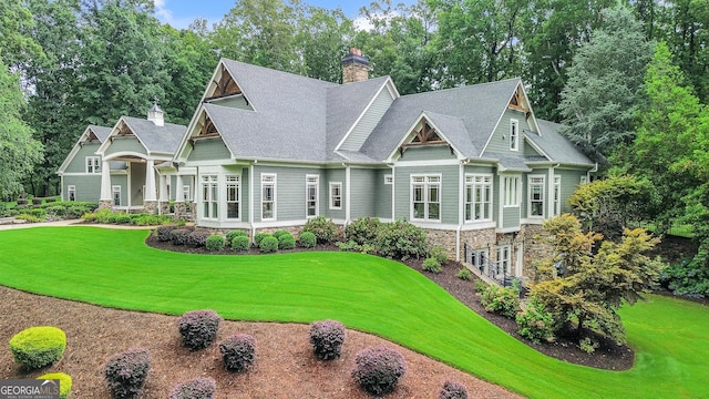 114 Trinity Hollow Dr, Canton, GA 30115 - craftsman inspired home featuring a chimney, a front lawn, and stone siding