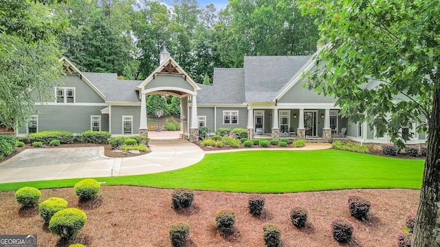 114 Trinity Hollow Dr, Canton, GA 30115 - craftsman house with a porch, a front lawn, and stone siding