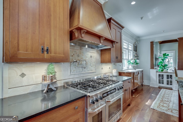 114 Trinity Hollow Dr, Canton, GA 30115 - kitchen with range with two ovens, custom exhaust hood, ornamental molding, wood finished floors, and baseboards