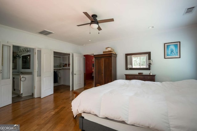 1079 Hardeman Farm Rd, Carnesville, GA 30521 - bedroom featuring crown molding, wood finished floors, connected bathroom, a walk in closet, and a closet