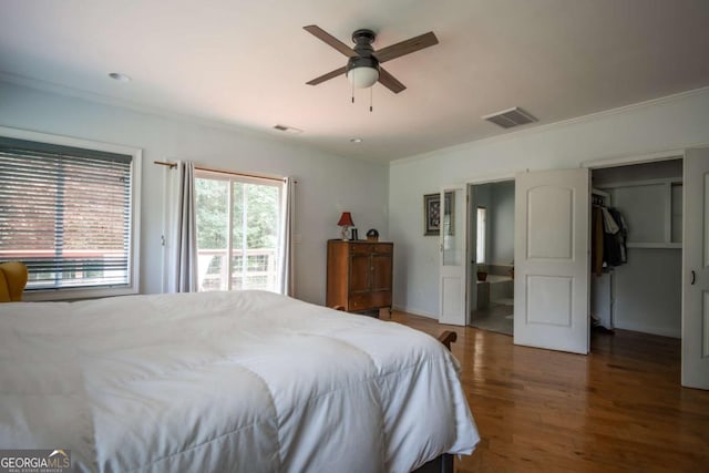 1079 Hardeman Farm Rd, Carnesville, GA 30521 - bedroom with ornamental molding, wood finished floors, access to exterior, a spacious closet, and a ceiling fan