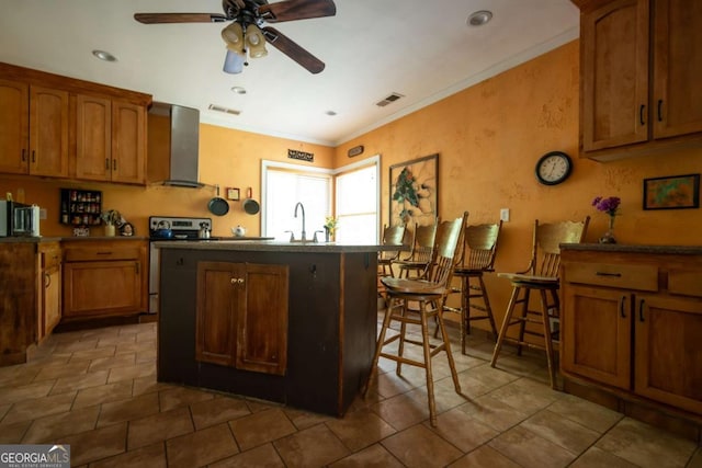 1079 Hardeman Farm Rd, Carnesville, GA 30521 - kitchen featuring wall chimney exhaust hood, stainless steel electric range oven, ceiling fan, a center island, and brown cabinets