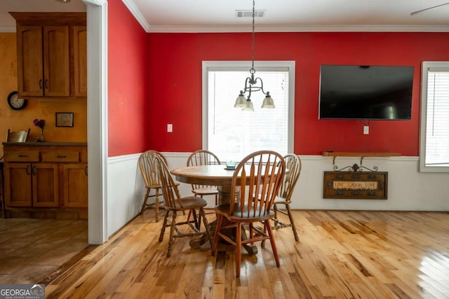 1079 Hardeman Farm Rd, Carnesville, GA 30521 - dining room with light wood finished floors, a wainscoted wall, and ornamental molding