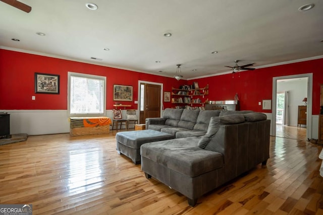 1079 Hardeman Farm Rd, Carnesville, GA 30521 - living area with a ceiling fan, plenty of natural light, ornamental molding, light wood-style flooring, and wainscoting