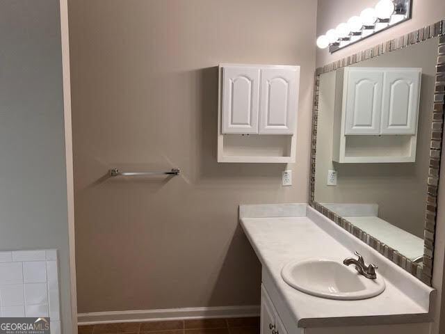 149 Titan Rd, Stockbridge, GA 30281 - bathroom featuring vanity, baseboards, and tile patterned flooring