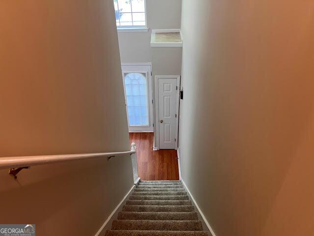 149 Titan Rd, Stockbridge, GA 30281 - stairway featuring baseboards and wood finished floors