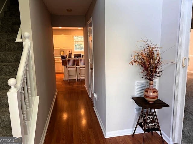 149 Titan Rd, Stockbridge, GA 30281 - hall with dark wood-style floors, stairway, and baseboards