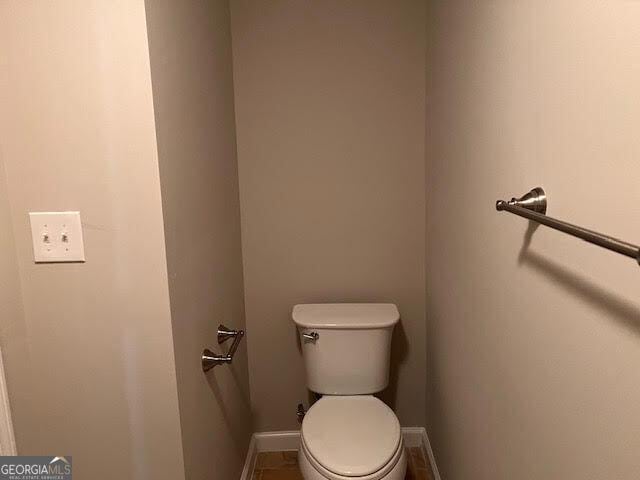 149 Titan Rd, Stockbridge, GA 30281 - bathroom featuring baseboards and toilet