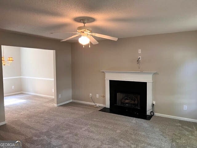 149 Titan Rd, Stockbridge, GA 30281 - unfurnished living room featuring carpet floors, ceiling fan, a fireplace with flush hearth, and baseboards