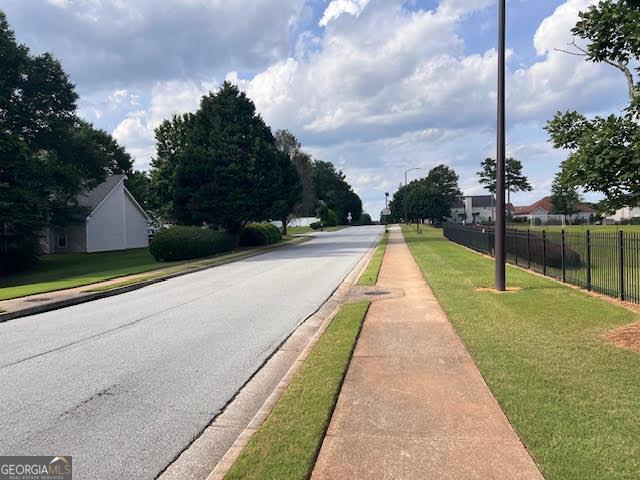 149 Titan Rd, Stockbridge, GA 30281 - view of asphalt street with sidewalks and curbs