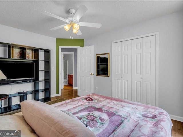 4517 Baker Grove Rd NW, Acworth, GA 30101 - bedroom with a closet, wood finished floors, ceiling fan, and a textured ceiling