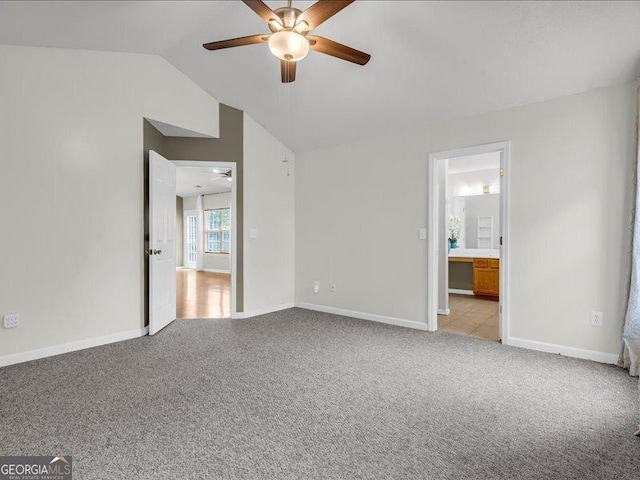 4517 Baker Grove Rd NW, Acworth, GA 30101 - unfurnished bedroom featuring light colored carpet, lofted ceiling, connected bathroom, and ceiling fan