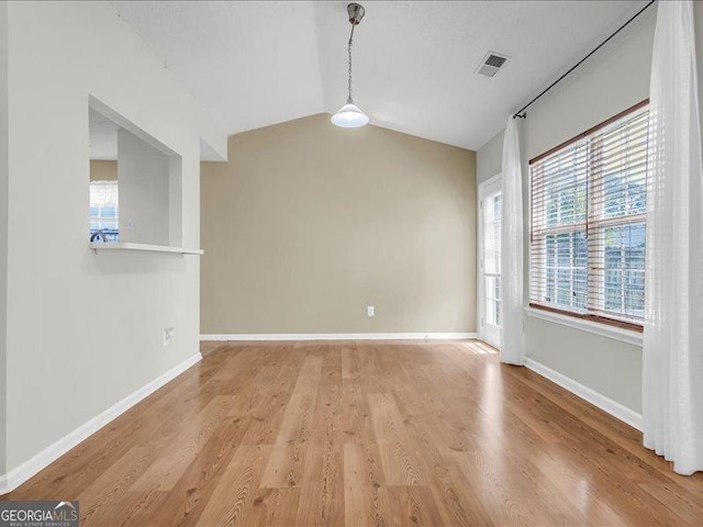 4517 Baker Grove Rd NW, Acworth, GA 30101 - unfurnished room with healthy amount of natural light, light wood-style floors, and vaulted ceiling
