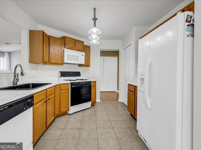 4517 Baker Grove Rd NW, Acworth, GA 30101 - kitchen with white appliances, light countertops, pendant lighting, and brown cabinets