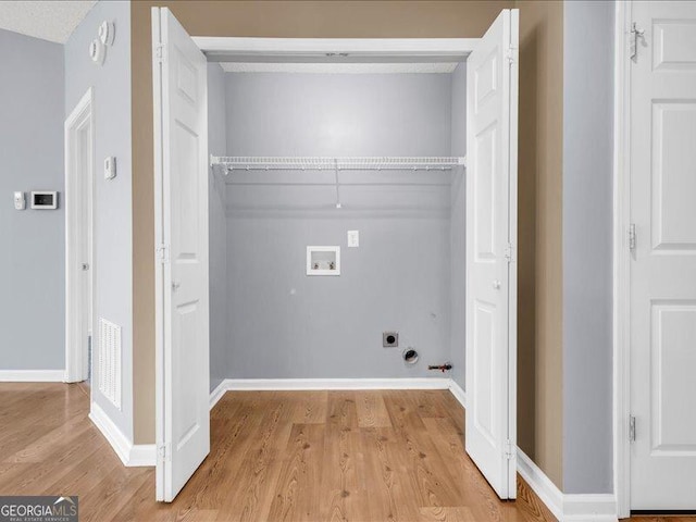 4517 Baker Grove Rd NW, Acworth, GA 30101 - laundry area featuring hookup for a washing machine, gas dryer hookup, light wood finished floors, and electric dryer hookup