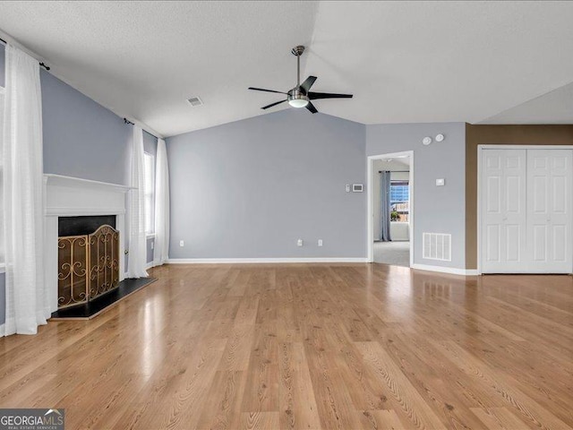 4517 Baker Grove Rd NW, Acworth, GA 30101 - unfurnished living room with ceiling fan, lofted ceiling, wood finished floors, and a fireplace with raised hearth