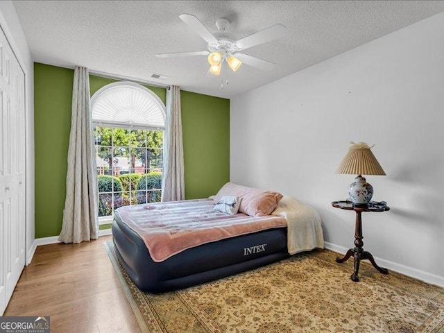 4517 Baker Grove Rd NW, Acworth, GA 30101 - bedroom with a textured ceiling, wood finished floors, and ceiling fan