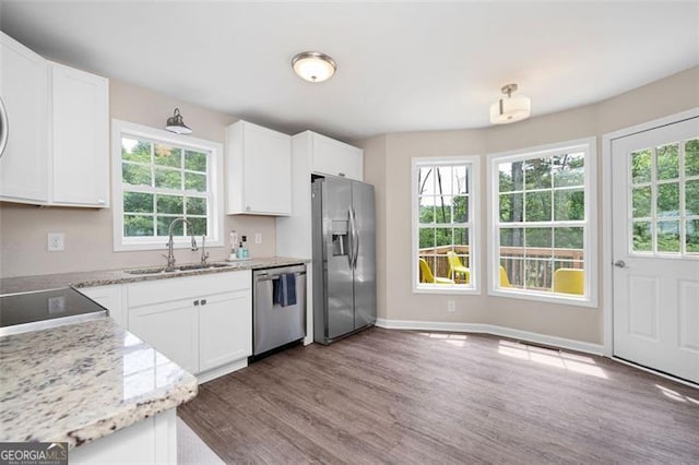 76 Vaughn NE, Cartersville, GA 30121 - kitchen featuring stainless steel appliances, a sink, wood finished floors, and white cabinets