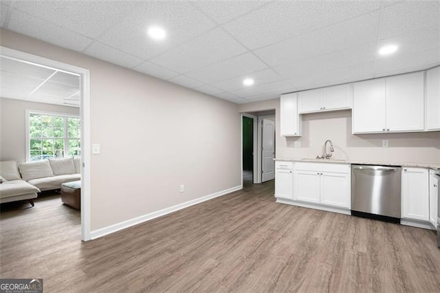 76 Vaughn NE, Cartersville, GA 30121 - kitchen featuring stainless steel dishwasher, light wood finished floors, a sink, white cabinets, and a paneled ceiling