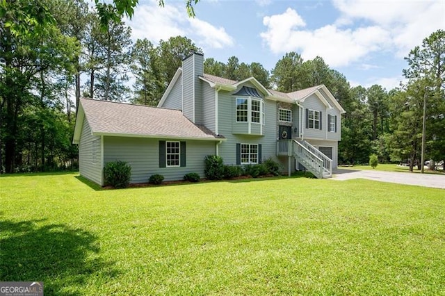 76 Vaughn NE, Cartersville, GA 30121 - bi-level home with driveway, a chimney, a front lawn, a garage, and a shingled roof