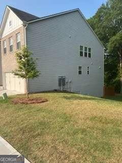 7695 Baron Rd, Fairburn, GA 30213 - view of home's exterior featuring a lawn
