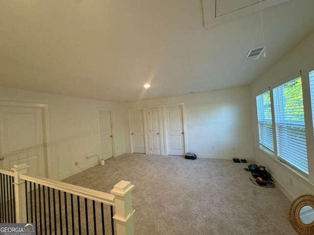 7695 Baron Rd, Fairburn, GA 30213 - carpeted empty room with baseboards and attic access