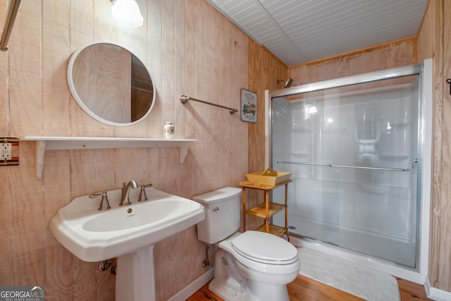 254 Rue Ln, Clayton, GA 30525 - bathroom with a shower stall, toilet, and wooden walls