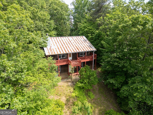 254 Rue Ln, Clayton, GA 30525 - view of front of home with metal roof, a forest view, and a deck