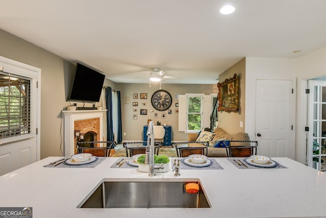 41 Wexford Cir, Cartersville, GA 30121 - kitchen with a sink, open floor plan, a brick fireplace, and light countertops