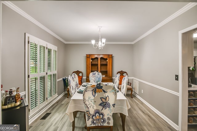 41 Wexford Cir, Cartersville, GA 30121 - dining area with a chandelier, wood finished floors, and crown molding